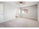 Bedroom with neutral carpet, a ceiling fan, closet, and a window with natural light at 6627 S 42Nd Pl, Phoenix, AZ 85042