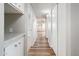 Bright hallway featuring wood floors, storage cabinets, and white walls at 6627 S 42Nd Pl, Phoenix, AZ 85042
