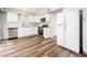 Bright kitchen features stainless steel appliances, sleek white cabinetry, and modern wood-look floors at 6627 S 42Nd Pl, Phoenix, AZ 85042
