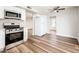 Open-concept kitchen has stainless appliances, white cabinets, and opens to the dining and living areas at 6627 S 42Nd Pl, Phoenix, AZ 85042