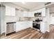 Updated kitchen features stainless steel appliances, sleek white cabinets, and modern countertops at 6627 S 42Nd Pl, Phoenix, AZ 85042