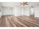 Bright open living room featuring laminate floors, fan and modern lighting at 6627 S 42Nd Pl, Phoenix, AZ 85042