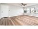 Bright and airy living room featuring new wood flooring and large windows at 6627 S 42Nd Pl, Phoenix, AZ 85042