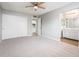 Bedroom with ceiling fan and ensuite bathroom with walk-in shower and ample storage at 6627 S 42Nd Pl, Phoenix, AZ 85042