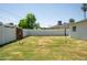 Large backyard area with a grass lawn, a palm tree, and a volleyball net at 6907 E Palm Ln, Scottsdale, AZ 85257