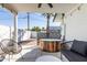 Inviting backyard featuring a modern wood-paneled hot tub and shaded seating area, perfect for outdoor relaxation at 6907 E Palm Ln, Scottsdale, AZ 85257