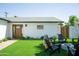 Relaxing backyard space with artificial grass, comfortable seating, and a cozy fire pit at 6907 E Palm Ln, Scottsdale, AZ 85257