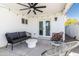 Relaxing backyard with patio seating, fan, and string lights, creating an inviting outdoor space at 6907 E Palm Ln, Scottsdale, AZ 85257
