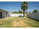 Backyard featuring a grass lawn, a palm tree, and a volleyball net at 6907 E Palm Ln, Scottsdale, AZ 85257
