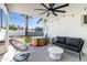 Cozy backyard under a ceiling fan, furnished with cushioned outdoor seating and a stylish wood hot tub at 6907 E Palm Ln, Scottsdale, AZ 85257