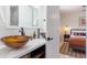 Modern bathroom featuring amber glass sinks, quartz countertops, and an en suite at 6907 E Palm Ln, Scottsdale, AZ 85257