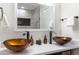 Bathroom featuring modern, amber glass sinks, quartz countertop, and brushed bronze faucets at 6907 E Palm Ln, Scottsdale, AZ 85257