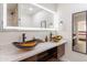 Bathroom with a lit mirror, double vessel sinks and a modern vanity at 6907 E Palm Ln, Scottsdale, AZ 85257