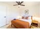 Well-lit bedroom featuring patterned pillows, stylish lamps, and a modern ceiling fan, creating a relaxing retreat at 6907 E Palm Ln, Scottsdale, AZ 85257