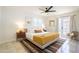 Bright bedroom featuring a comfortable bed, modern nightstands, and a doorway leading to an outdoor area at 6907 E Palm Ln, Scottsdale, AZ 85257
