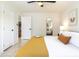 Bright bedroom with tiled floors, a cozy bed, and a glimpse into the adjacent living space at 6907 E Palm Ln, Scottsdale, AZ 85257