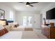 Bedroom with two beds, ceiling fan, and french doors leading to the backyard at 6907 E Palm Ln, Scottsdale, AZ 85257