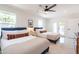 Bright bedroom featuring two queen beds, white tile floors, and access to outdoor space at 6907 E Palm Ln, Scottsdale, AZ 85257