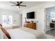Large bedroom features two beds, ceiling fan, and adjacent bathroom at 6907 E Palm Ln, Scottsdale, AZ 85257