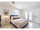 Bright bedroom featuring a queen bed, a white nightstand, and access to the outdoor space at 6907 E Palm Ln, Scottsdale, AZ 85257
