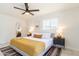 Bright bedroom featuring a ceiling fan, decorative rug, and modern furnishings, creating a cozy and stylish retreat at 6907 E Palm Ln, Scottsdale, AZ 85257