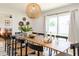 Open dining area with a long table, seating for eight, and stylish decor throughout at 6907 E Palm Ln, Scottsdale, AZ 85257