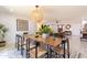 Charming dining area with a large wooden table and seating for eight, adjacent to the living room at 6907 E Palm Ln, Scottsdale, AZ 85257