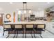 Bright kitchen featuring white cabinets, stainless steel appliances, and a center island with seating at 6907 E Palm Ln, Scottsdale, AZ 85257