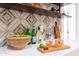 Bright kitchen with tile backsplash, quartz countertops, bar accessories, and open shelving at 6907 E Palm Ln, Scottsdale, AZ 85257