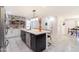Modern kitchen features a spacious island, stainless steel appliances, and stylish black and white cabinetry at 6907 E Palm Ln, Scottsdale, AZ 85257