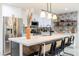 Modern kitchen boasting stainless steel appliances, white cabinetry, and a large center island with seating at 6907 E Palm Ln, Scottsdale, AZ 85257