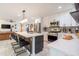 Modern kitchen featuring stainless steel appliances, white cabinets, quartz countertops, and bar stool seating at 6907 E Palm Ln, Scottsdale, AZ 85257