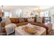 Cozy living area with a plush leather sectional, soft lighting, and a stylish coffee table at 6907 E Palm Ln, Scottsdale, AZ 85257