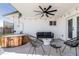Covered patio featuring a hot tub, a ceiling fan, and modern outdoor furniture at 6907 E Palm Ln, Scottsdale, AZ 85257