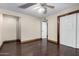 Bedroom has wood floors, trim, and sliding doors leading to the closet and another room at 7126 N 19Th Ave # 228, Phoenix, AZ 85021
