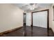Bedroom features wood floors, closet with sliding doors, ceiling fan and baseboard trim at 7126 N 19Th Ave # 228, Phoenix, AZ 85021