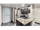 Modern kitchen featuring stainless steel refrigerator, granite countertops, and ample cabinetry at 7126 N 19Th Ave # 228, Phoenix, AZ 85021