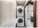 Laundry room features stacked washer and dryer with folding counter and sliding door to kitchen at 7126 N 19Th Ave # 228, Phoenix, AZ 85021