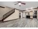 Bright living area featuring a staircase, laundry, and wood-look tile flooring at 7126 N 19Th Ave # 228, Phoenix, AZ 85021