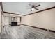 Spacious living room with modern wood-look floors and stylish ceiling fan at 7126 N 19Th Ave # 228, Phoenix, AZ 85021