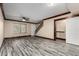 Open living space with wood-look flooring, staircase, and a sliding door closet at 7126 N 19Th Ave # 228, Phoenix, AZ 85021