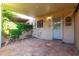 Inviting covered patio featuring classic tile flooring and climbing floral vines for a charming outdoor space at 7126 N 19Th Ave # 228, Phoenix, AZ 85021