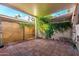 Covered patio has brick flooring, block walls with lush vines, and a view of the sky at 7126 N 19Th Ave # 228, Phoenix, AZ 85021