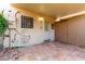 Charming covered patio with terracotta tile, a secure door, and convenient access to storage at 7126 N 19Th Ave # 228, Phoenix, AZ 85021
