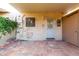 Charming covered patio with classic tile flooring, secure access, and climbing floral vines at 7126 N 19Th Ave # 228, Phoenix, AZ 85021