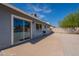 View of backyard with grill and large sliding glass door, connecting the outdoors to the home at 719 W Pampa Ave, Mesa, AZ 85210