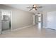 Bedroom with tile floors, lighted ceiling fan and ensuite bathroom at 719 W Pampa Ave, Mesa, AZ 85210