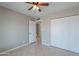 Bedroom with tile floors, ceiling fan, neutral walls and standard closet at 719 W Pampa Ave, Mesa, AZ 85210