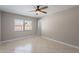 Neutral bedroom with ceiling fan, tiled floor, window, and access to the rest of the house at 719 W Pampa Ave, Mesa, AZ 85210