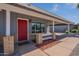 Inviting entryway with a striking red front door and covered porch, enhancing curb appeal at 719 W Pampa Ave, Mesa, AZ 85210